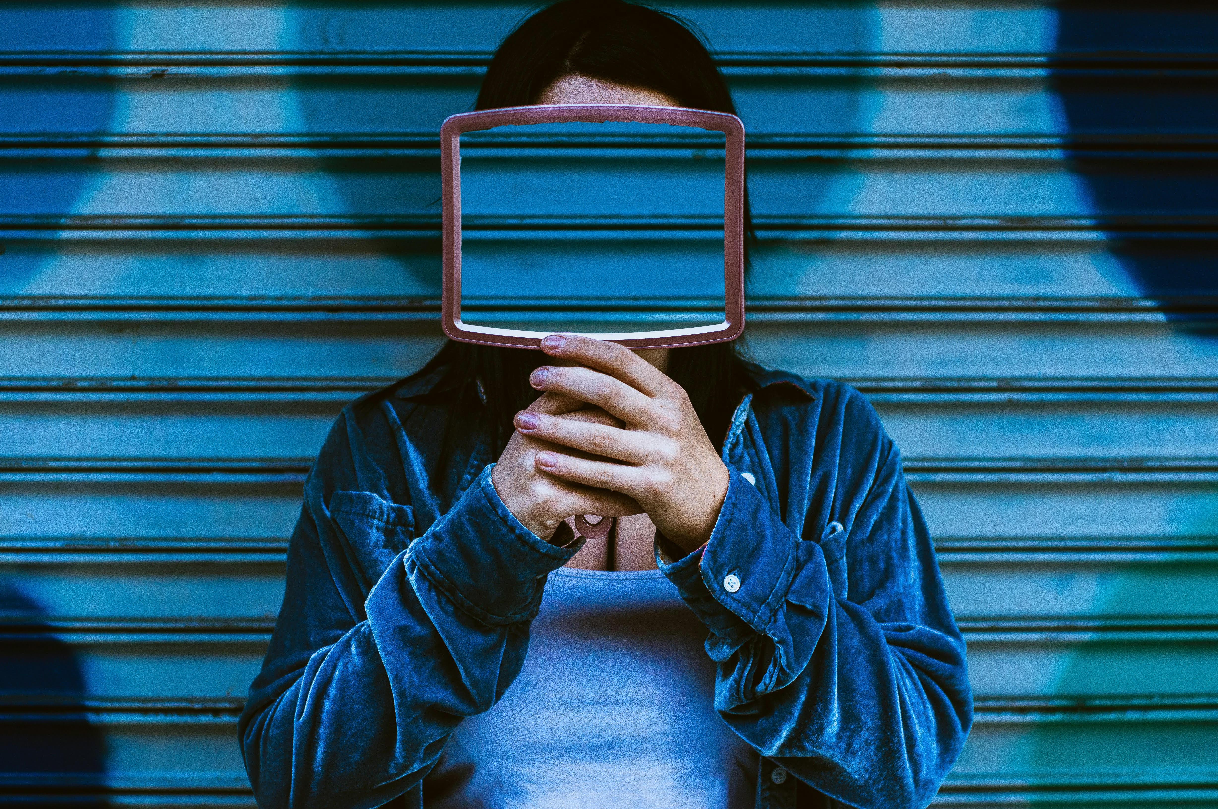 Faceless brand holding a mirror